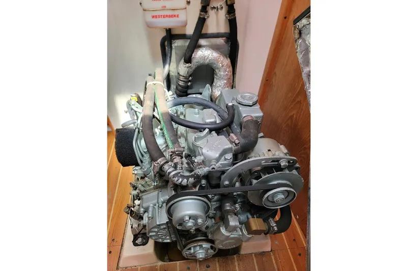 Slide: The Image of Engine compartment of a 2006 Catalina 310 sailboat, featuring a Westerbeke engine. - 12