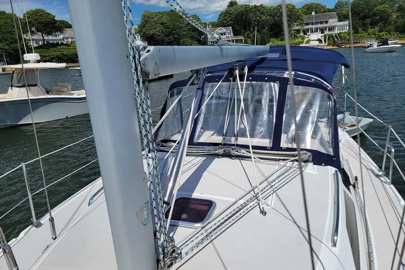 Slide: The Image of Catalina 310 sailboat, 2006 model, docked in a scenic marina with clear skies. - 22