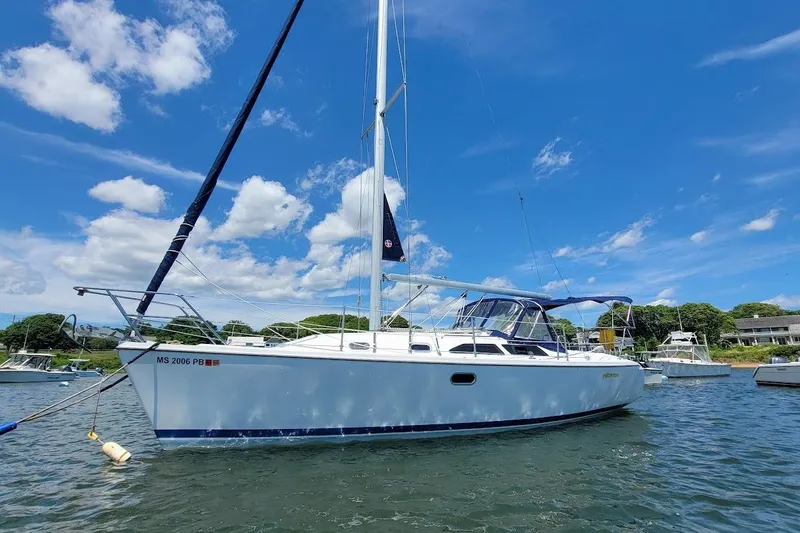 Slide: The Image of 2006 Catalina 310 sailboat on water under clear blue sky. - 24