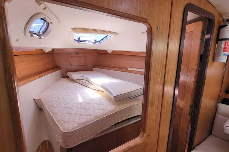 Slide: The Image of Cozy cabin interior of a 2006 Catalina 310 sailboat with a comfortable bed. - 5