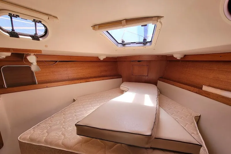 Slide: The Image of Cozy cabin interior of a 2006 Catalina 310 sailboat with a comfortable bed. - 6
