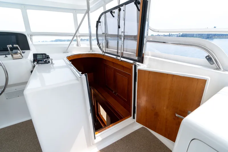 Slide: The Image of 2009 Outer Reef Yachts Motor Yacht helm with open wooden hatch and navigation equipment. - 28