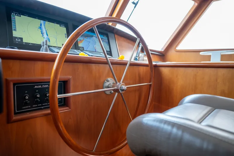 Slide: The Image of Steering wheel and navigation screens on 2009 Outer Reef Yachts Motor Yacht helm. - 13