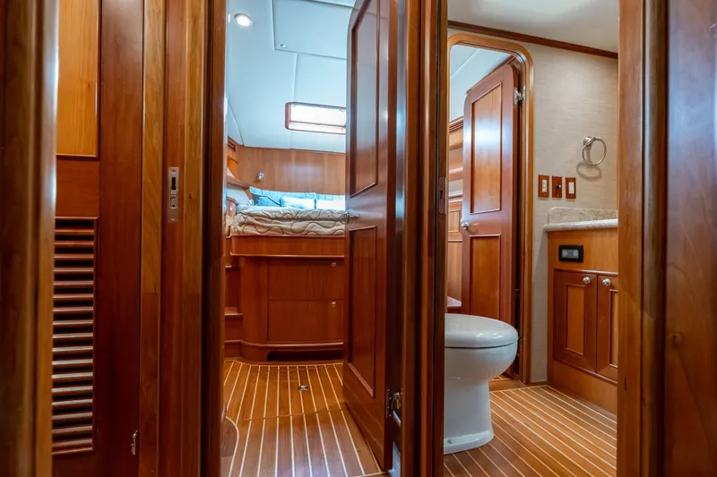 Slide: The Image of Luxurious 2009 Outer Reef Yachts motor yacht interior with wood finish and cozy bedroom. - 22