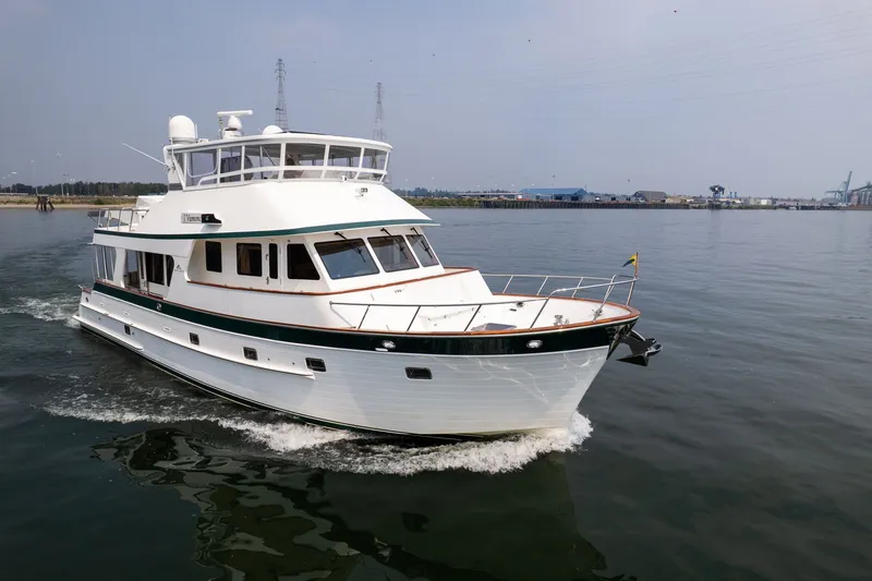 Slide: The Image of 2009 Outer Reef Yachts Motor Yacht cruising on calm waters near an industrial shoreline. - 52
