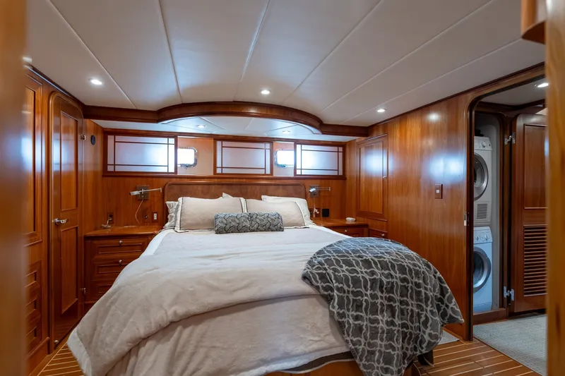 Slide: The Image of Luxurious 2009 Outer Reef Yachts motor yacht bedroom with wood paneling and cozy bedding. - 19
