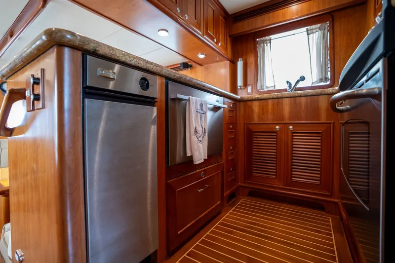 Slide: The Image of Luxurious 2009 Outer Reef Yachts motor yacht kitchen with wood cabinetry and stainless steel appliances. - 9