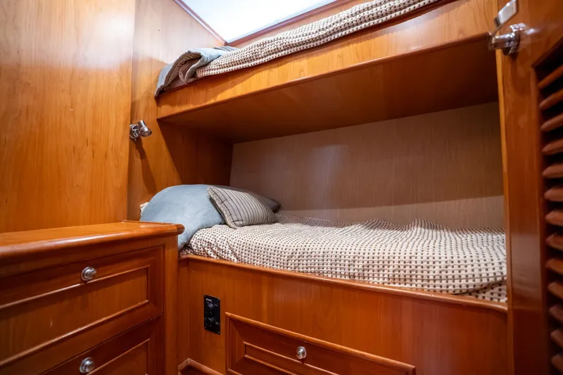 Slide: The Image of Cozy wooden bunk beds in a 2009 Outer Reef Yachts motor yacht cabin. - 26