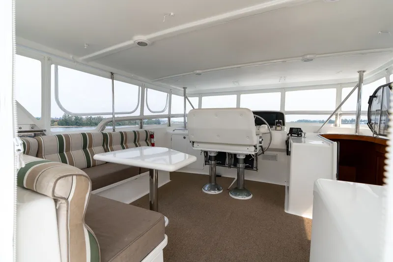 Slide: The Image of Spacious 2009 Outer Reef Yachts motor yacht interior with helm, seating, and panoramic windows. - 29