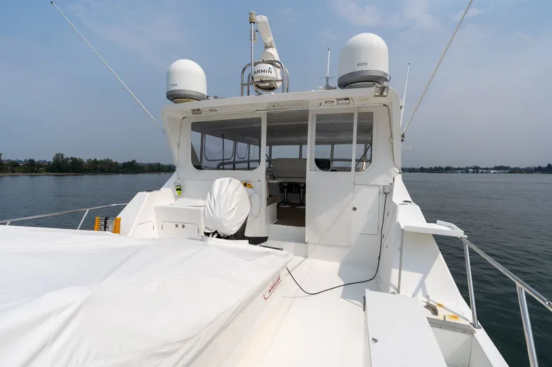 Slide: The Image of 2009 Outer Reef Yachts Motor Yacht on calm water, showcasing deck and navigation equipment. - 35