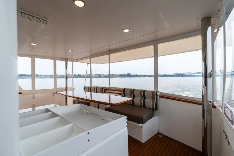 Slide: The Image of 2009 Outer Reef Yachts Motor Yacht interior with seating area, overlooking serene water and distant bridge. - 43