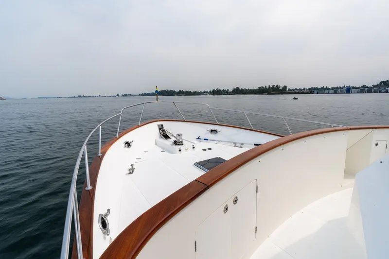 Slide: The Image of 2009 Outer Reef Yachts Motor Yacht on calm waters, showcasing deck and railing. - 41