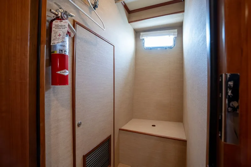 Slide: The Image of Interior of 2009 Outer Reef Yachts Motor Yacht with fire extinguisher and small window. - 27