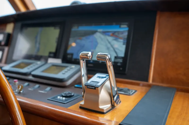 Slide: The Image of Control panel of a 2009 Outer Reef Yachts Motor Yacht with navigation screens and throttle levers. - 15