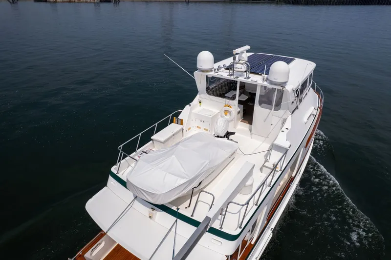 Slide: The Image of 2009 Outer Reef Yachts Motor Yacht cruising on calm waters, showcasing its spacious deck and sleek design. - 56