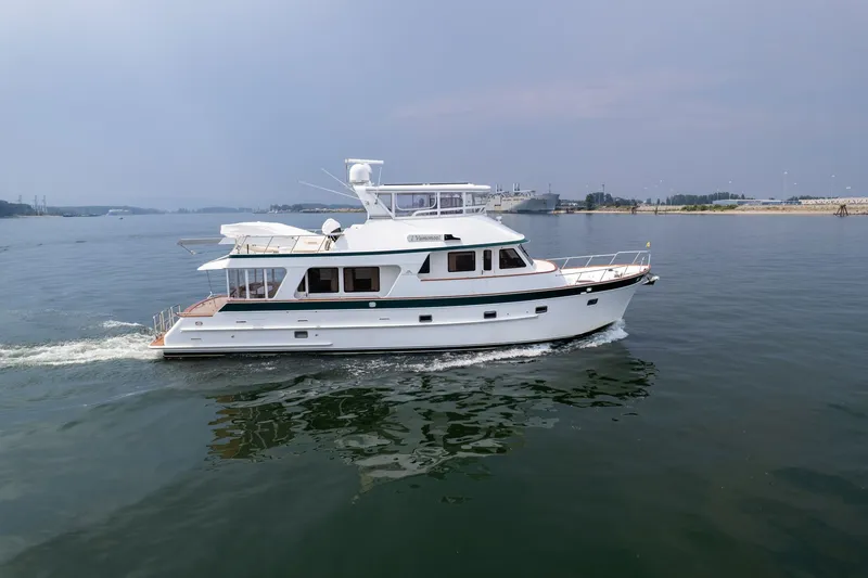 Slide: The Image of 2009 Outer Reef Yachts Motor Yacht cruising on calm waters under a clear sky. - 59