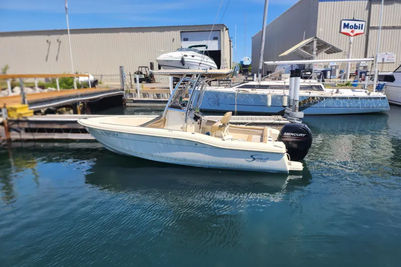 The Image of 2014 Scout 210 XSF boat docked at marina with Mercury outboard engine. - 0