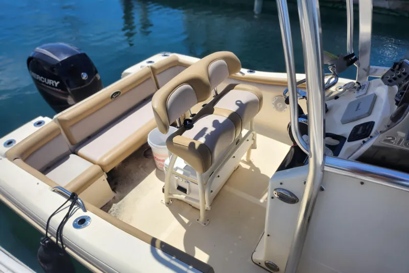Slide: The Image of 2014 Scout 210 XSF boat interior with seating and Mercury outboard motor. - 6