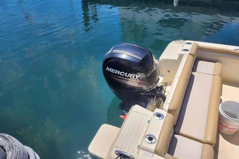 Slide: The Image of 2014 Scout 210 XSF boat with Mercury outboard motor on clear water. - 7