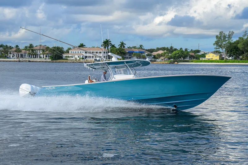 Slide: The Image of 2020 Valhalla V-41 boat cruising on a scenic waterway with waterfront homes. - 11