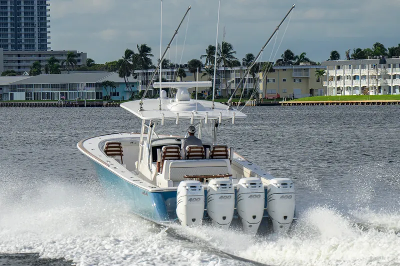 Slide: The Image of 2020 Valhalla V-41 boat cruising on water with four powerful engines. - 14