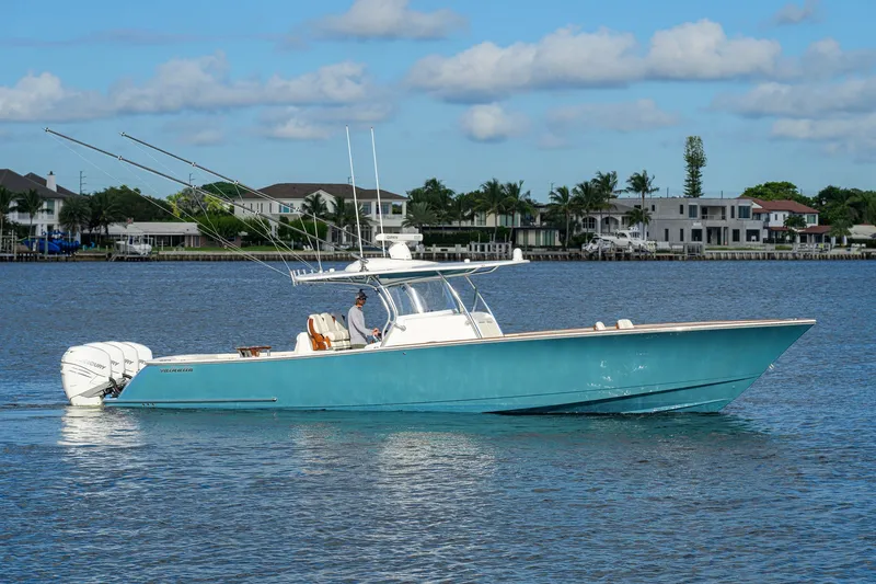 The Image of 2020 Valhalla V-41 boat cruising on a calm blue waterway with waterfront homes in the background. - 0