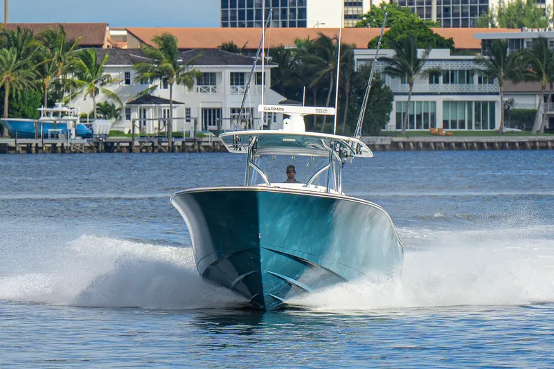Slide: The Image of 2020 Valhalla V-41 boat cruising on water near waterfront homes. - 12