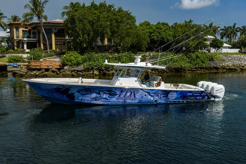 Slide: The Image of 2020 Valhalla Boatworks V-41 with custom graphics, cruising near waterfront homes. - 9