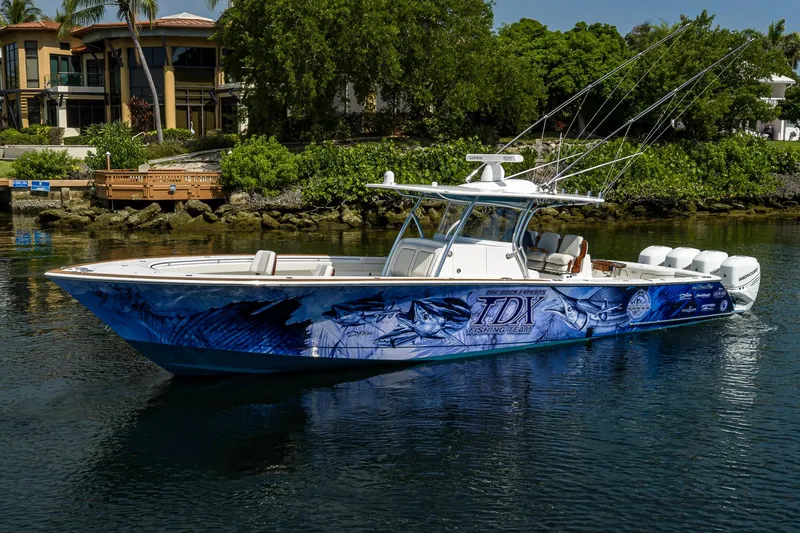 Slide: The Image of 2020 Valhalla Boatworks V-41 with custom graphics, docked near luxury waterfront homes. - 8