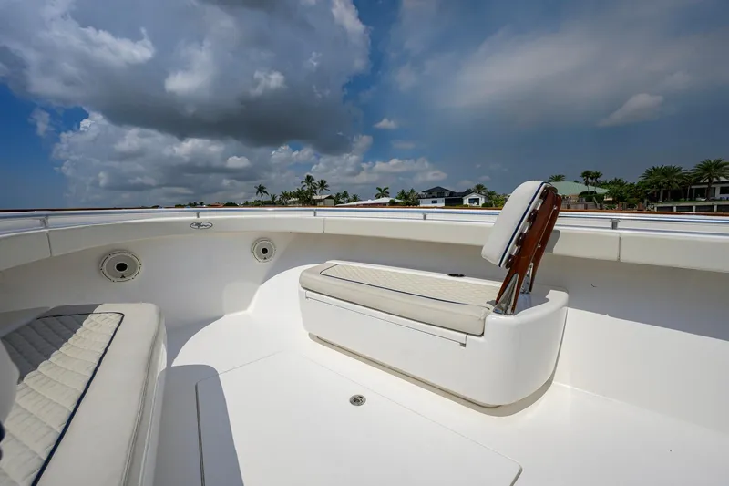 Slide: The Image of 2020 Valhalla Boatworks V-41 interior with cushioned seating under a cloudy sky. - 32