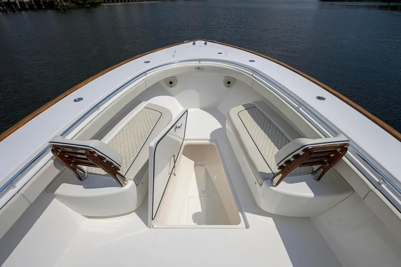 Slide: The Image of Valhalla Boatworks V-41 (2020) bow seating area with storage compartment, on calm water. - 42