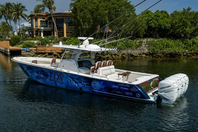 Slide: The Image of 2020 Valhalla Boatworks V-41 with vibrant graphics, docked near lush greenery. - 10