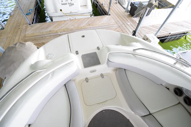 Slide: The Image of The image shows the cockpit of a 2010 Bryant 255 boat with white upholstery. - 10