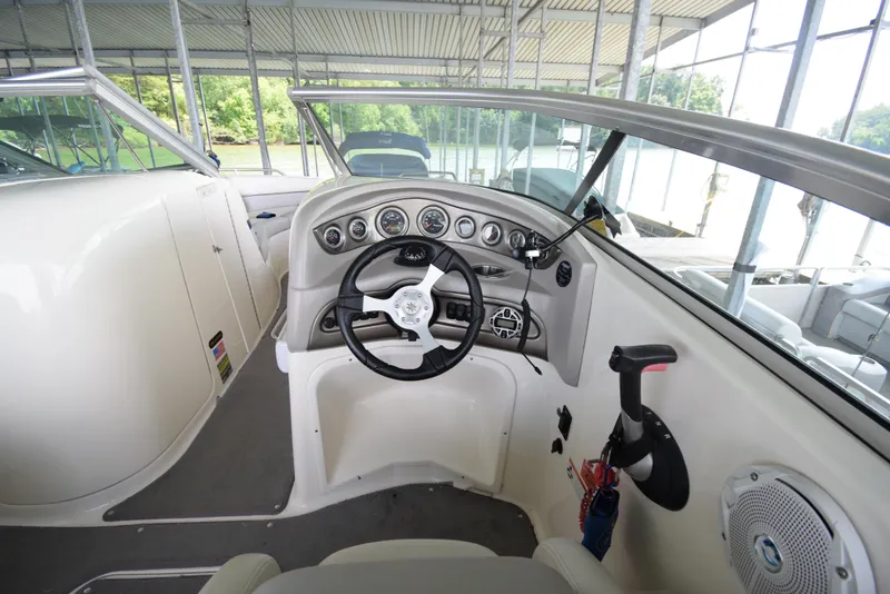 Slide: The Image of The image shows the cockpit of a 2010 Bryant 255 boat with a modern helm. - 15