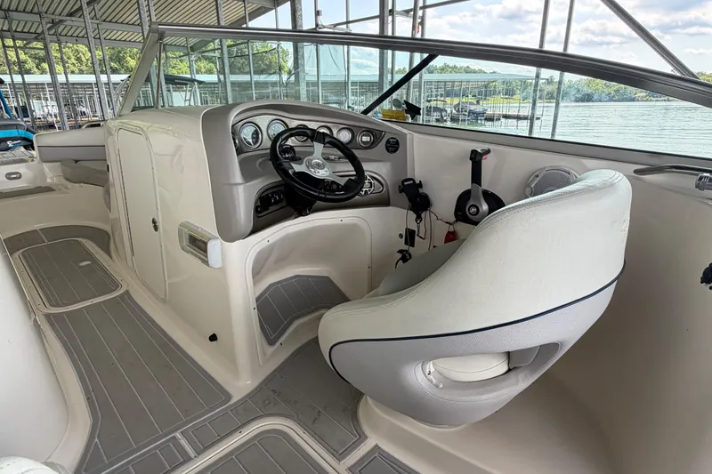 Slide: The Image of Interior of a 2010 Bryant 255 boat with steering wheel and dashboard. - 18