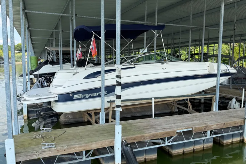 Slide: The Image of 2010 Bryant 255 boat docked under covered marina. - 2