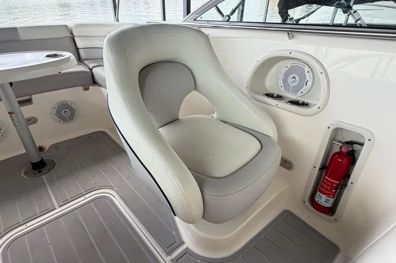 Slide: The Image of Luxurious seating area on a 2010 Bryant 255 boat with speaker and fire extinguisher. - 23
