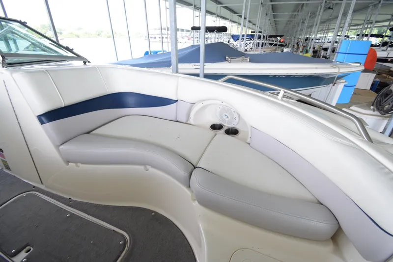 Slide: The Image of The image shows the cockpit of a 2010 Bryant 255 boat with white and blue seating. - 27