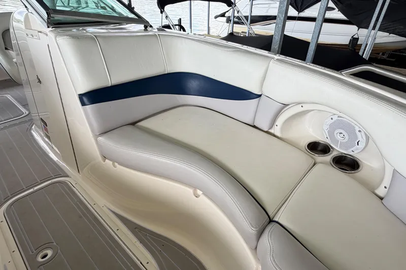 Slide: The Image of Luxurious seating on a 2010 Bryant 255 boat with cup holders and speaker. - 28
