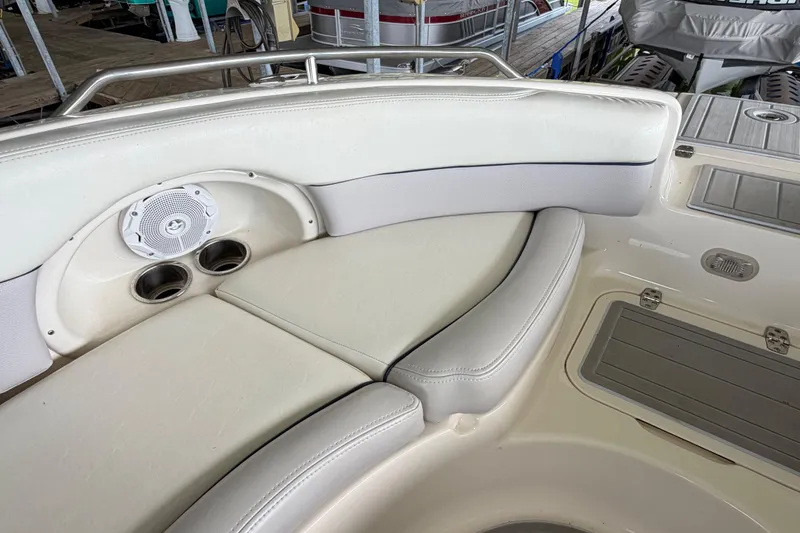 Slide: The Image of Interior of a 2010 Bryant 255 boat with cushioned seating and built-in speaker. - 31