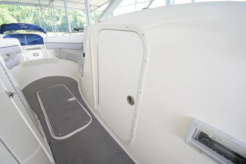 Slide: The Image of The image shows the interior of a 2010 Bryant 255 boat with white and gray details. - 35