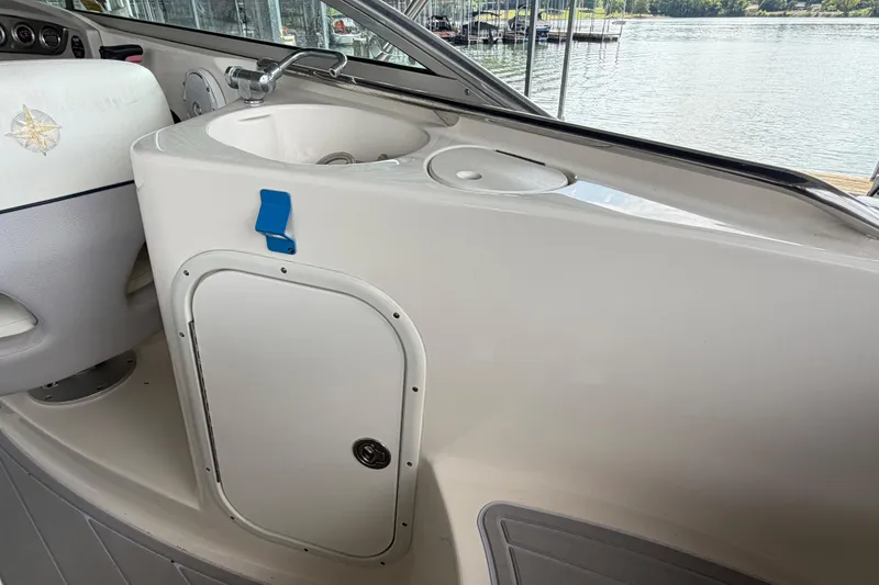 Slide: The Image of Interior of a 2010 Bryant 255 boat featuring a sink and storage compartment. - 36