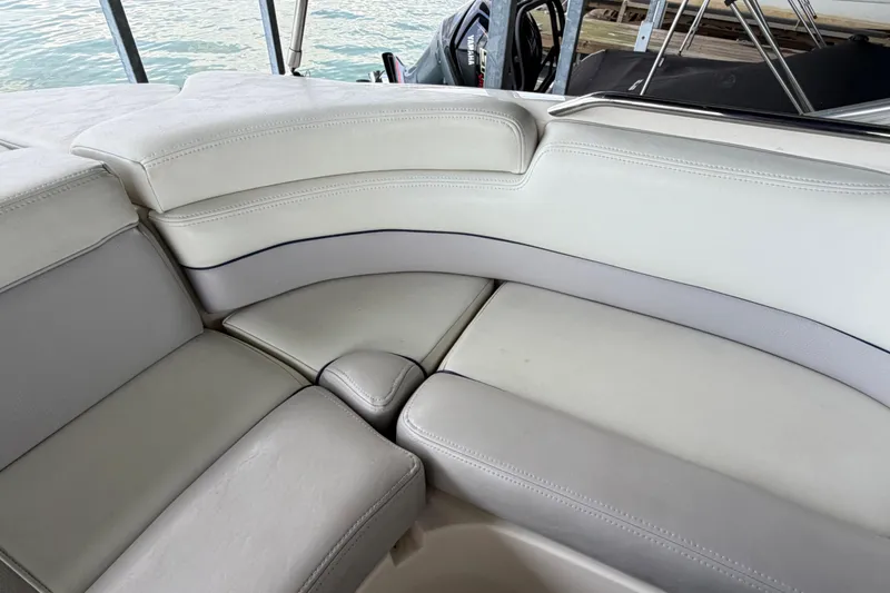 Slide: The Image of Luxurious seating on a 2010 Bryant 255 boat, featuring white leather upholstery. - 39