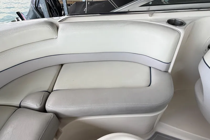Slide: The Image of Interior seating of a 2010 Bryant 255 boat with white upholstery. - 40