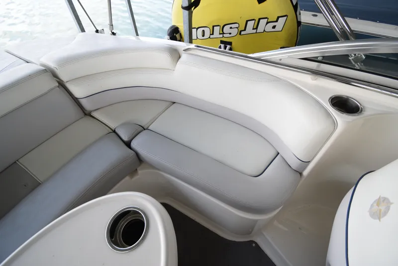 Slide: The Image of Interior of a 2010 Bryant 255 boat with white upholstered seating. - 41