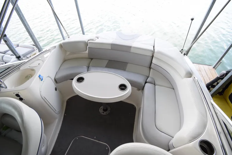 Slide: The Image of The image shows the cockpit of a 2010 Bryant 255 boat with white cushioned seating. - 42