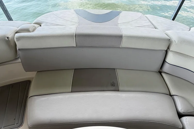 Slide: The Image of Rear seating area of a 2010 Bryant 255 boat with beige upholstery. - 43