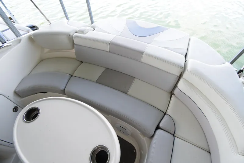 Slide: The Image of The image shows a white and gray curved seating area on a boat with a table in the center. - 46