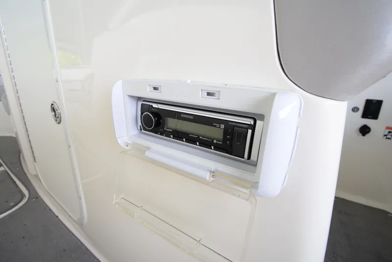 Slide: The Image of A built-in radio on a boat panel with white surfaces. - 48