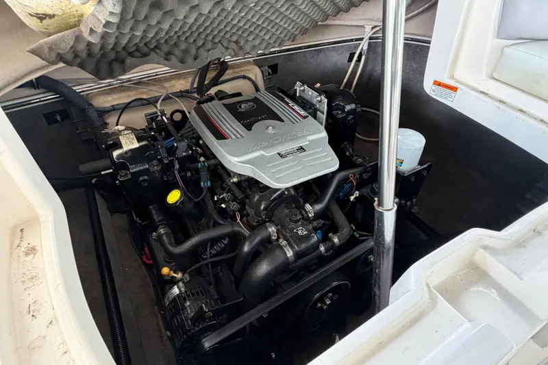 Slide: The Image of Engine compartment of a 2010 Bryant 255 boat, featuring a MerCruiser engine. - 53